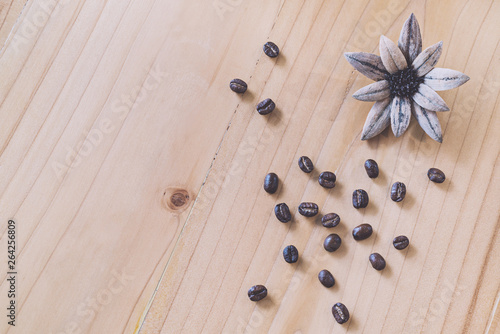 Close up of Coffee beans on wood background in vintage tone color style, selective focus (detailed close-up shot)