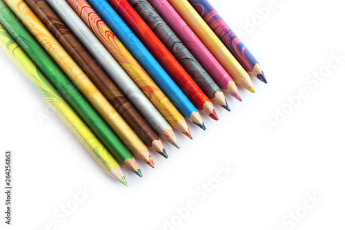 Color pencils on a white background. Spectrum of a rainbow. Back to school. Selective focus, close-up.
