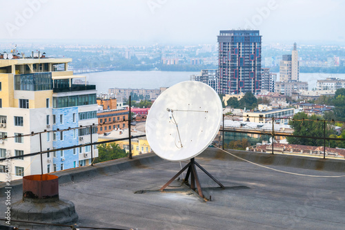 Fotografija Direct-focus satellite dish is on the roof of a high building
