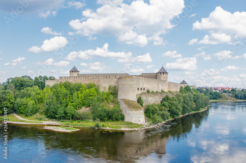 Ivangorod fortress on the Bank of the Narva river in the summer noon © IrinaK