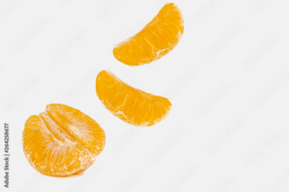 Falling mandarin slices on a white background Falling mandarin slices on a white background