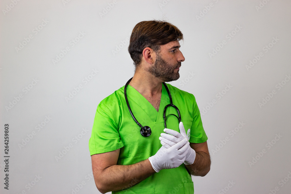 Portrait of male veterinary doctor in green uniform with brown hair winking the eye, facing forwards and looking at the side. Isolated on white background. Portrait of male veterinary doctor in green uniform with brown hair winking the eye, facing forwards and looking at the side. Isolated on white background.