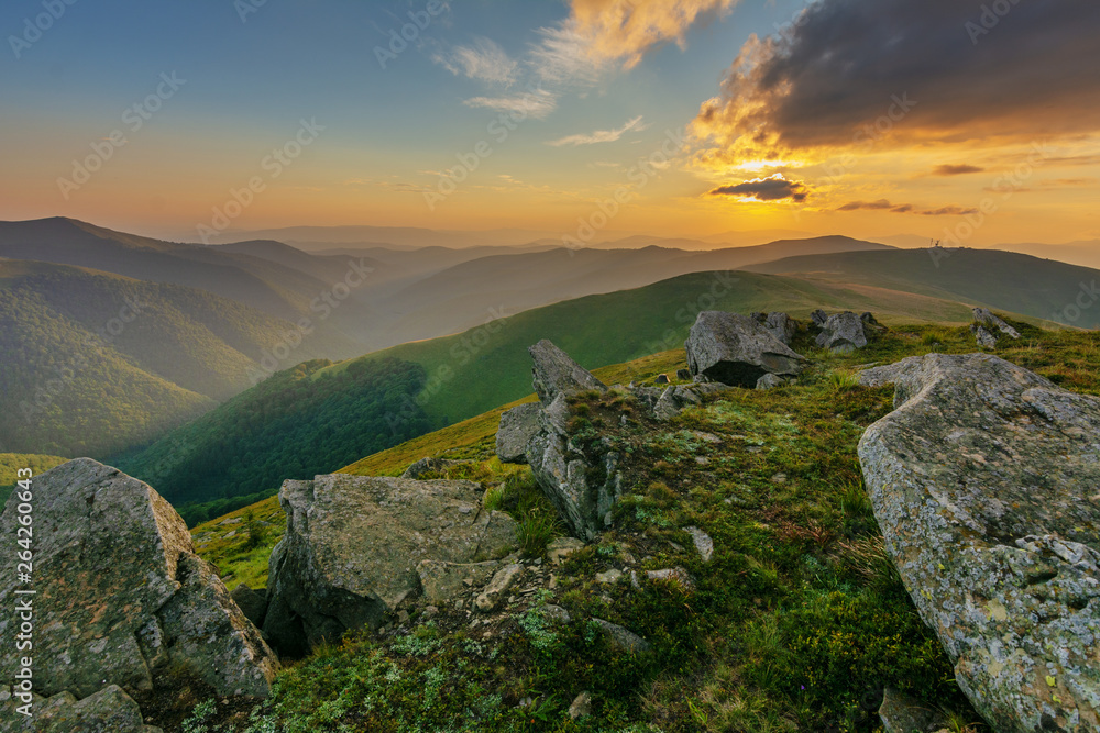 Mountain scenery in the Ukrainian Carpathians in the summer with a tourist in the background of the sunset