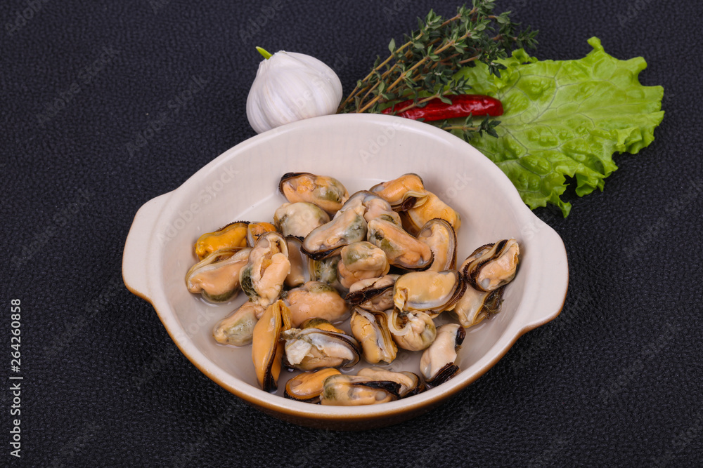 Pickled mussels in the bowl served pepper, garlic and salad Pickled mussels in the bowl served pepper, garlic and salad
