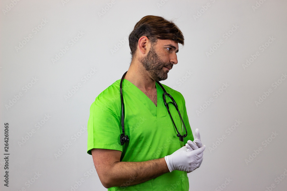 Portrait of male veterinary doctor in green uniform with brown hair and a look of disgust, facing forwards and looking at the side. Isolated on white background. Portrait of male veterinary doctor in green uniform with brown hair and a look of disgust, facing forwards and looking at the side. Isolated on white background.