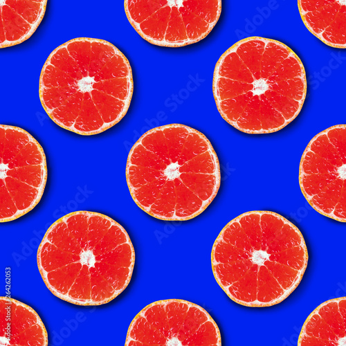 Seamless pattern made of red tangerine on a bright blue background