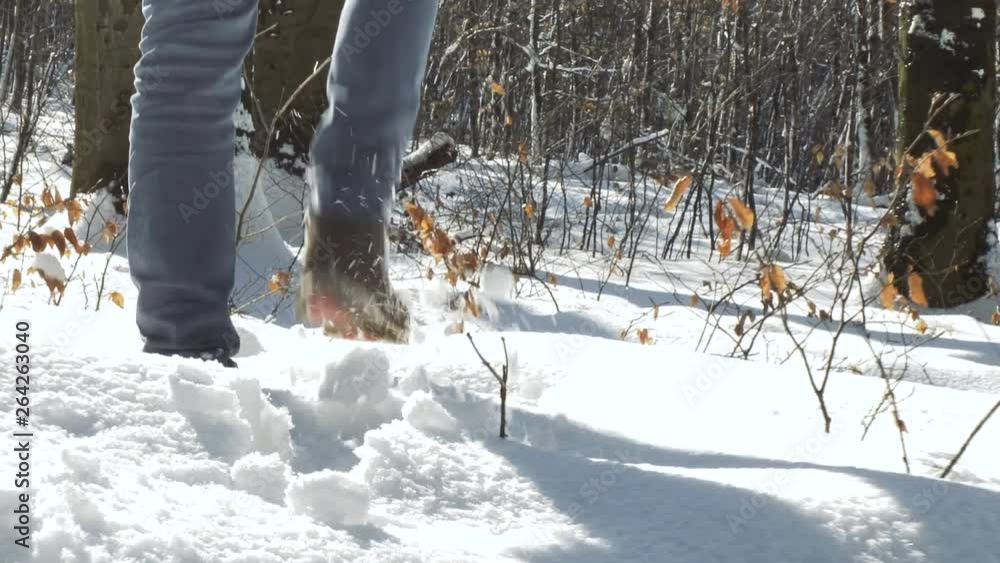 Walking feet in boots in winter forest Walking feet in boots in winter forest