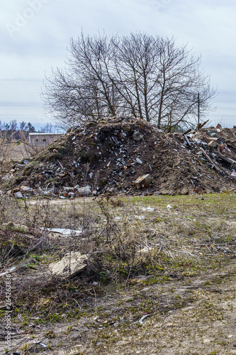 heaps of rubbish and stones at the site of a ruined farm