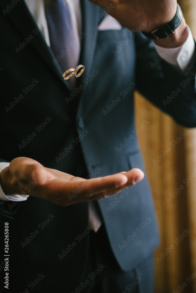 Groom throws up wedding rings. Groom throws rings by hand