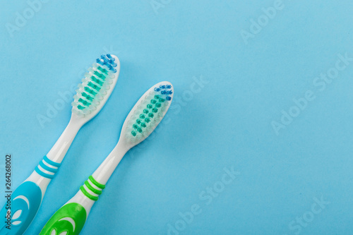 Two new toothbrush on a blue background. concept