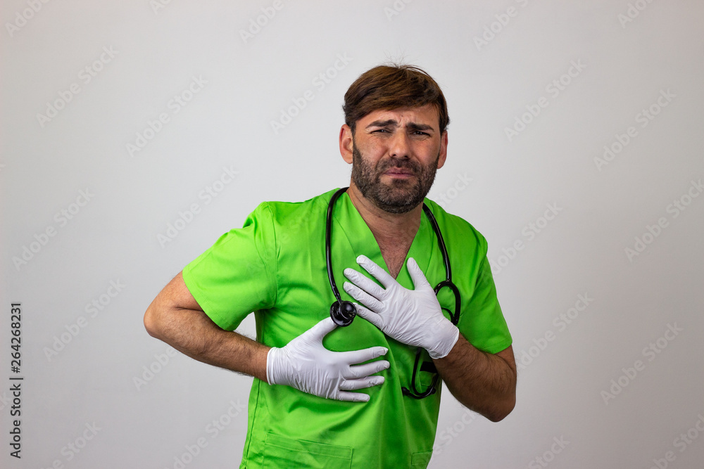 Portrait of male veterinary doctor in green uniform with brown hair suffering, their back facing the camera and looking at the camera. Isolated on white background. Portrait of male veterinary doctor in green uniform with brown hair suffering, their back facing the camera and looking at the camera. Isolated on white background.