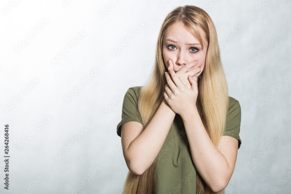 Surprised young woman covers mouth in shock. Surprised young woman covers mouth in shock.