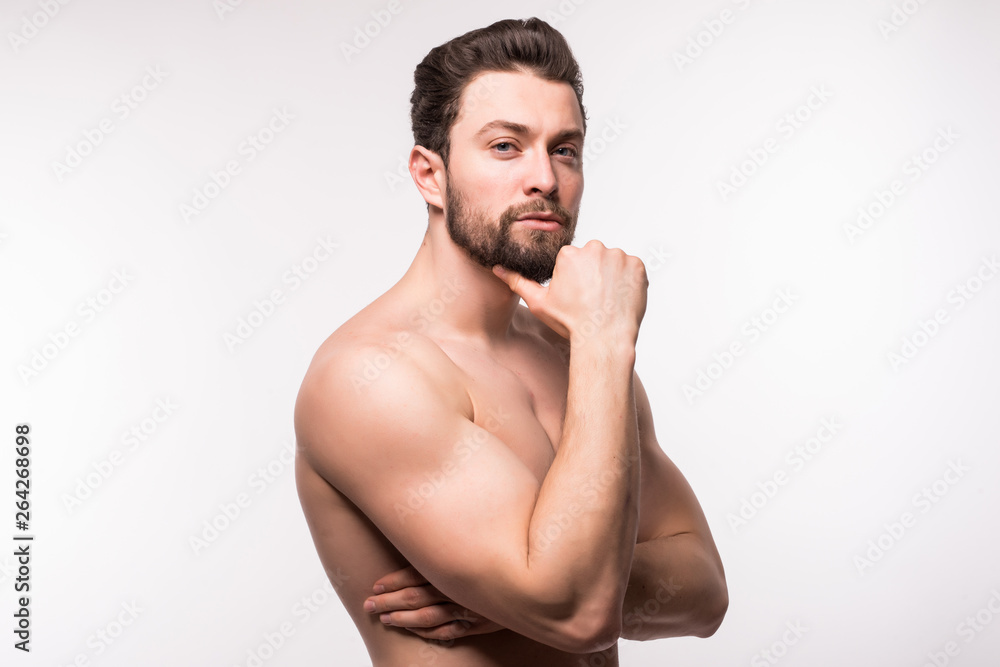 Fototapeta premium Side view portrait of a young man with nude torso over white background