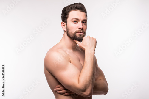 Side view portrait of a young man with nude torso over white background