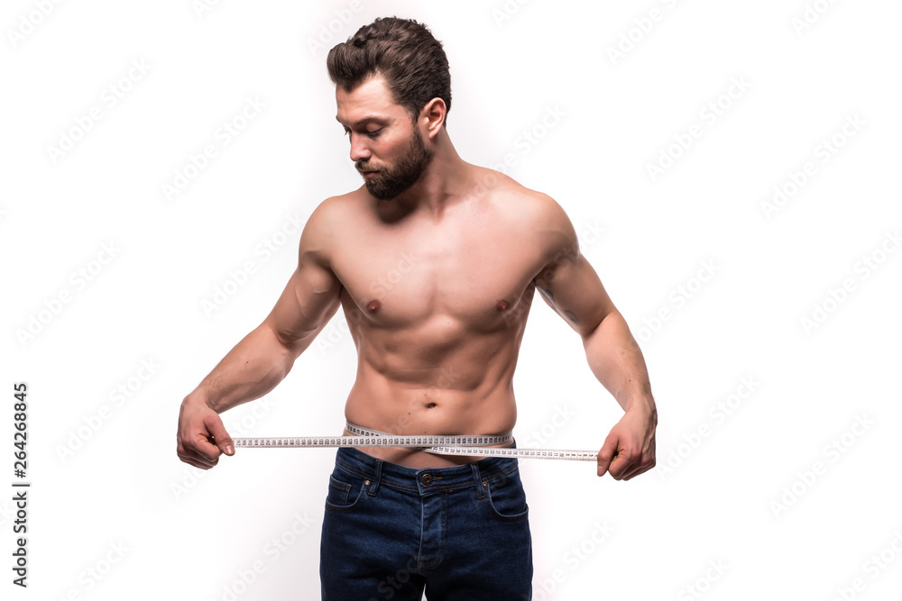 Young man use measurement tape for his torso isolated on white background Young man use measurement tape for his torso isolated on white background