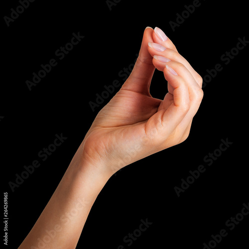 Woman hand holding something little with two fingers