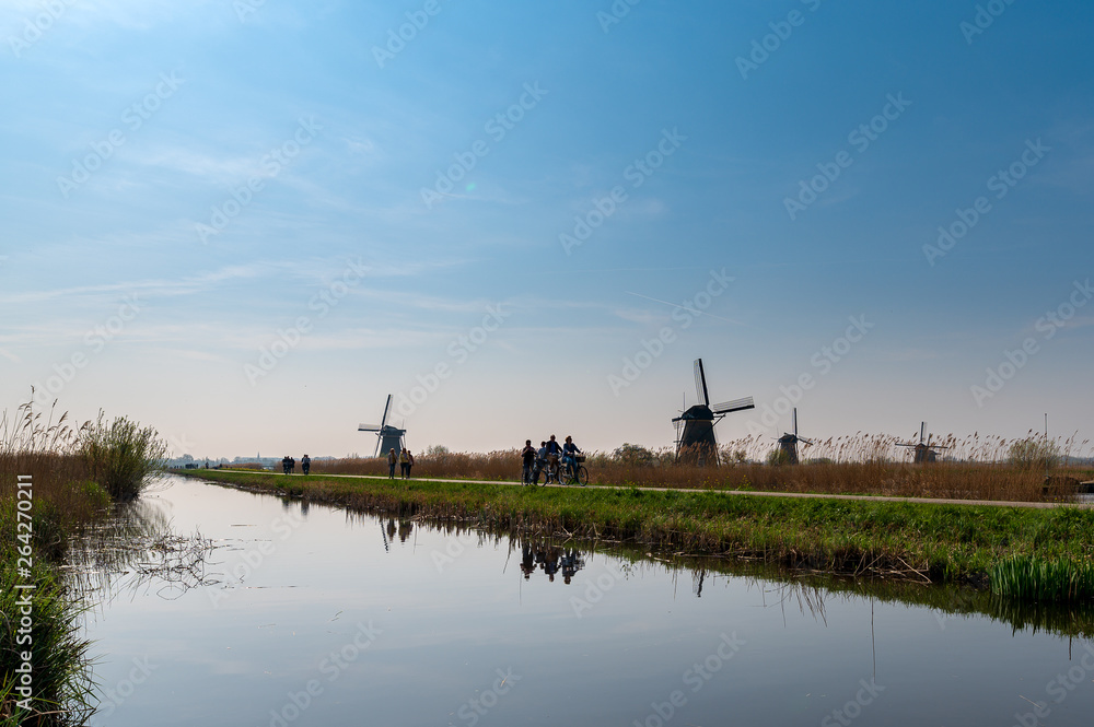 dutch windmills in holland by a river canal