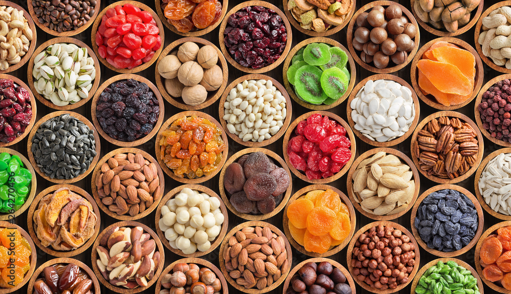 assorted nuts and dried fruit background. organic food in wooden bowls, top view. - obrazy, fototapety, plakaty 