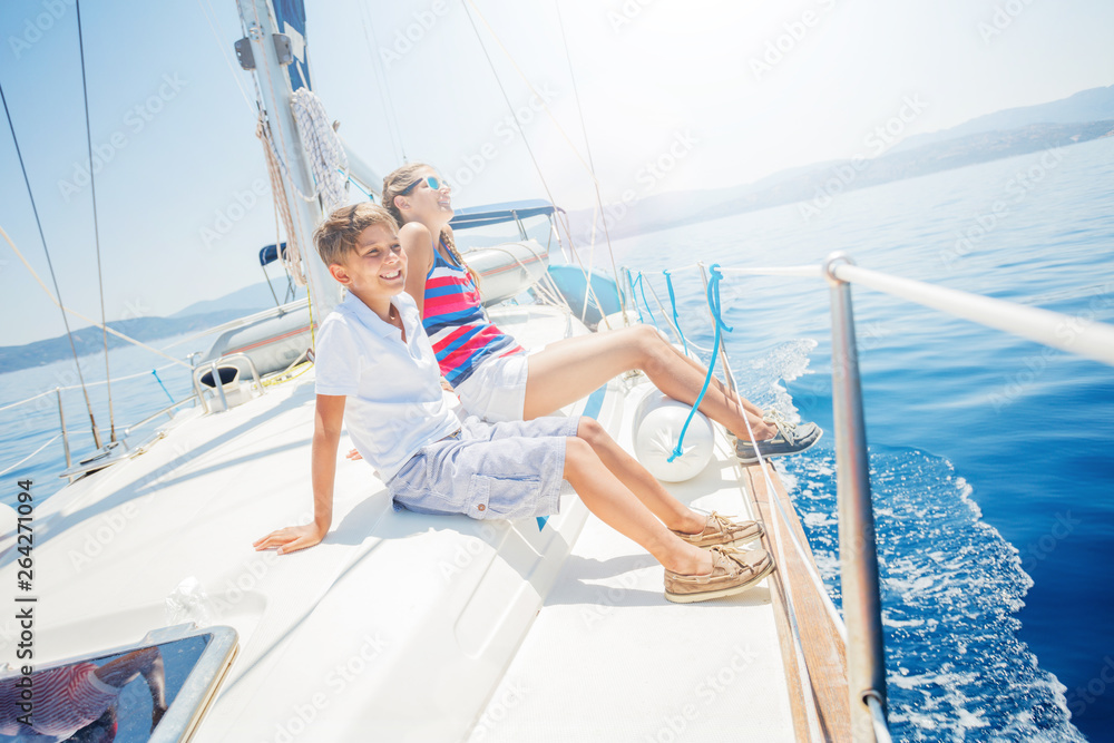 Boy with his sister on board of sailing yacht on summer cruise. Boy with his sister on board of sailing yacht on summer cruise.