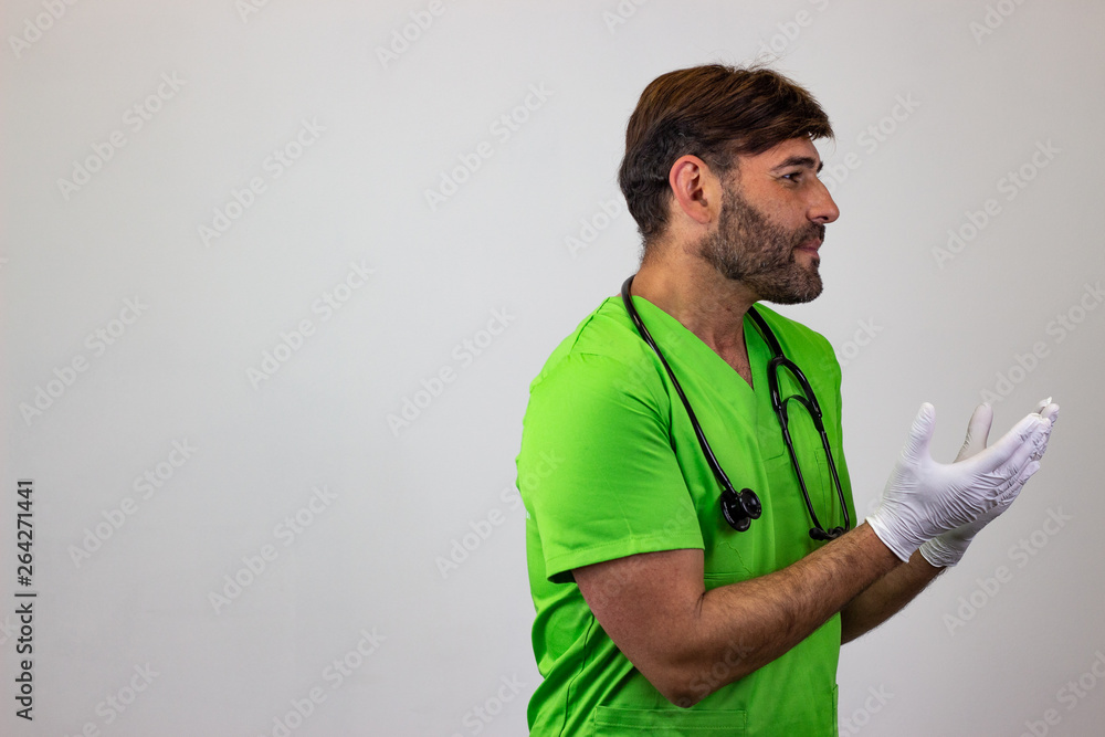 Portrait of male veterinary doctor in green uniform with brown hair passionate, facing forwards and looking at the side. Isolated on white background. Portrait of male veterinary doctor in green uniform with brown hair passionate, facing forwards and looking at the side. Isolated on white background.