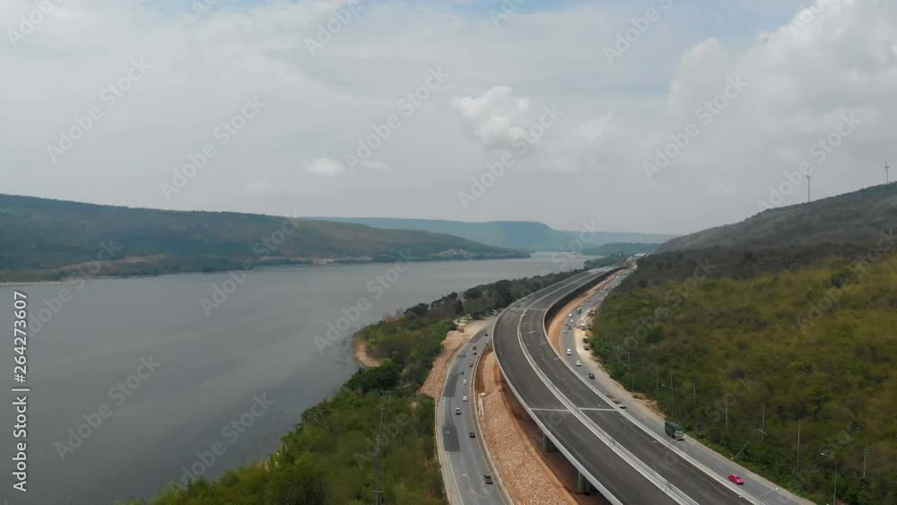 Drone shot aerial view of under construction motorway express way toll nearly natural big river and mountain Drone shot aerial view of under construction motorway express way toll nearly natural big river and mountain