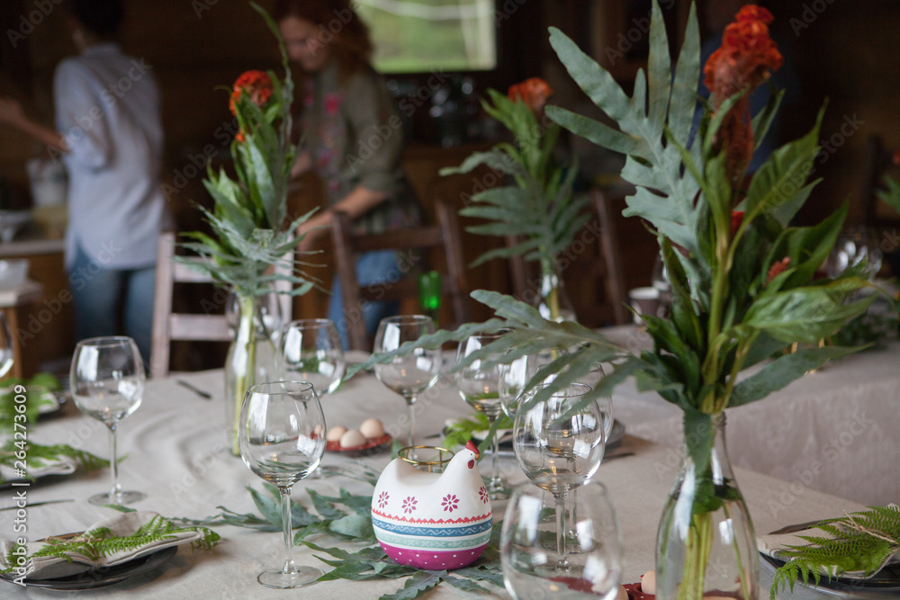Festive table setting with fern leaves and forest flowers