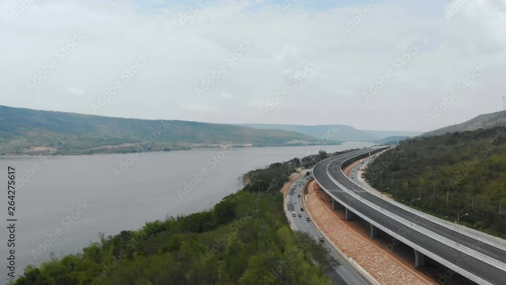 Drone shot aerial view of under construction motorway express way toll nearly natural big river and mountain Drone shot aerial view of under construction motorway express way toll nearly natural big river and mountain