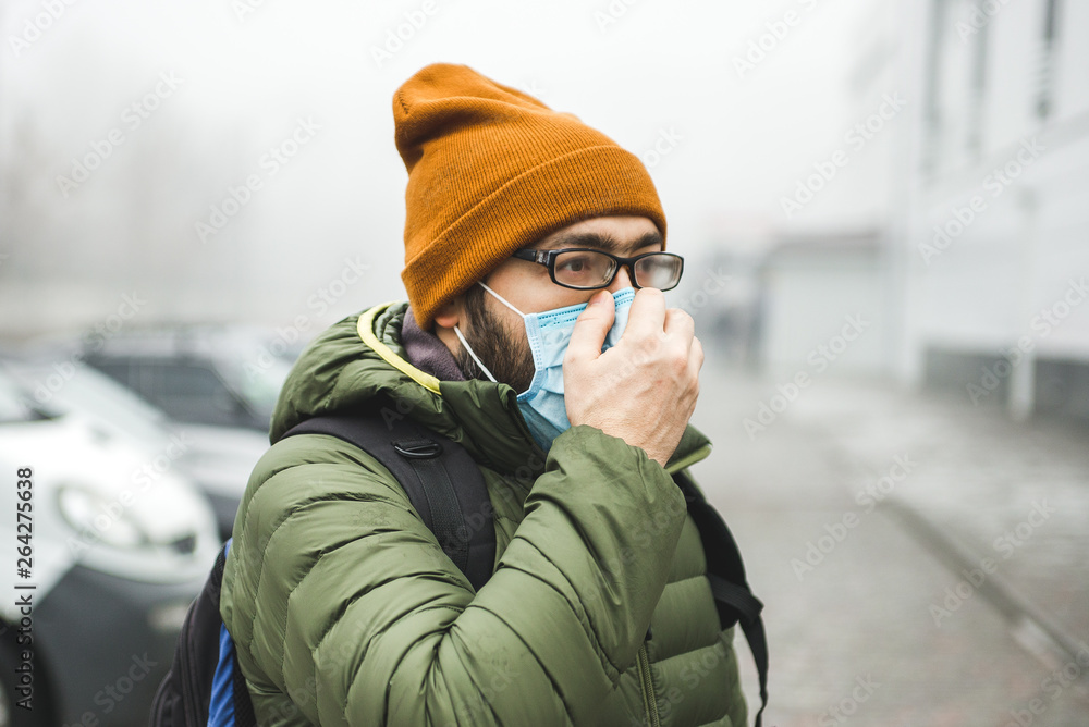 A man wearing a mask on the street. Protection against virus and grip A man wearing a mask on the street. Protection against virus and grip