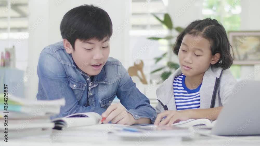 Young boys are using computers to teach and explain homework. To friends with facial expressions and happy gestures, Dolly shoot 60fps. Young boys are using computers to teach and explain homework. To friends with facial expressions and happy gestures, Dolly shoot 60fps.