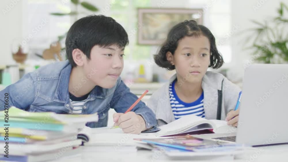 Young boys are using computers to teach and explain homework. To friends with facial expressions and happy gestures, Dolly shoot 60fps. Young boys are using computers to teach and explain homework. To friends with facial expressions and happy gestures, Dolly shoot 60fps.
