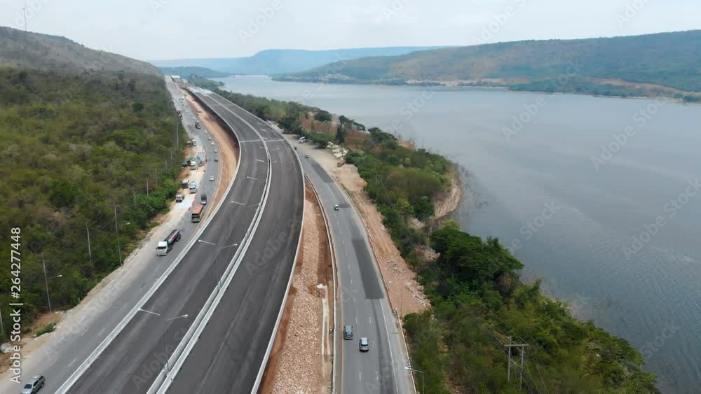Drone shot aerial view of under construction motorway express way toll nearly natural big river and mountain Drone shot aerial view of under construction motorway express way toll nearly natural big river and mountain