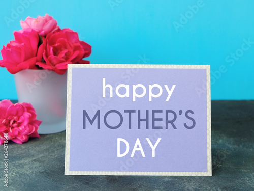 Mothers day card with pink rose bouquet and blue background. Bright colors for holiday graphic.