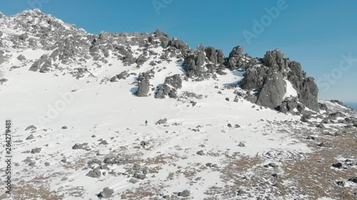 Wallpaper Mural Travel in winter: man mountaineering in winter mountains,  aerial video. Drone flight mountain landscape, man backpacker hiking sunny day. Tourism, nature and trekking concepts.  Torontodigital.ca