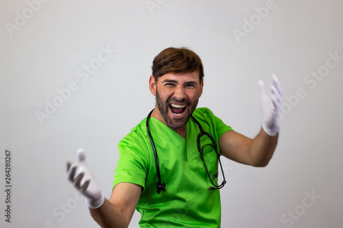 Portrait of male veterinary doctor in green uniform with brown hair looking with lust, their back facing the camera and looking at the camera. Isolated on white background.
