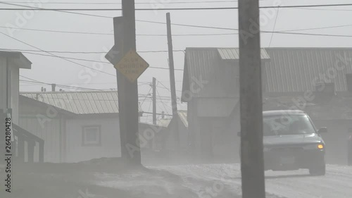 Cars driving in a gloomy village in the mist, Alaska