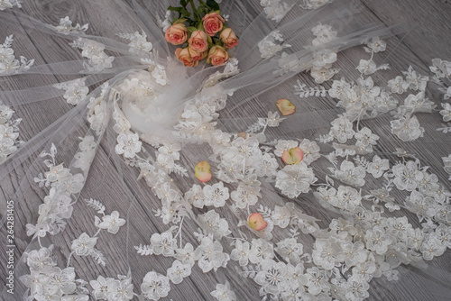 The texture of lace on wooden background decoreted roses. photo