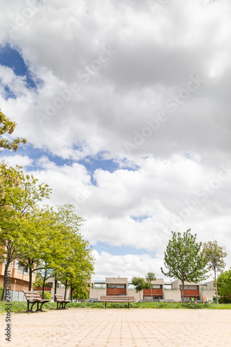 Street with Banks Park and houses and blue sky © Sergio