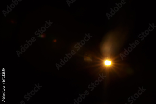 Abstract Natural Sun flare on the black background.