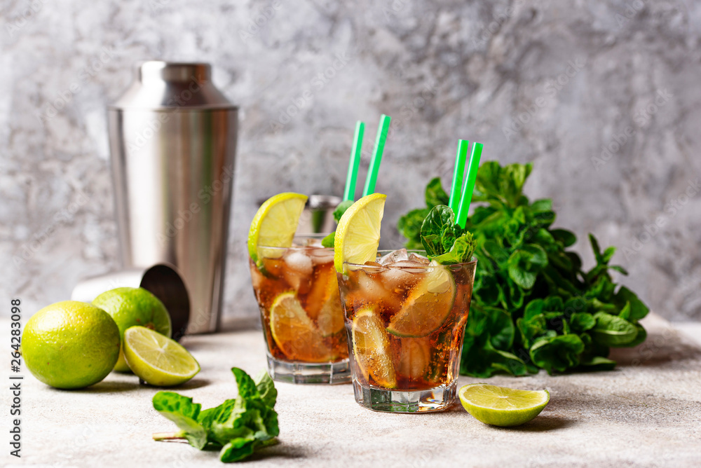 Cuba libre cocktail with mint and lime Cuba libre cocktail with mint and lime