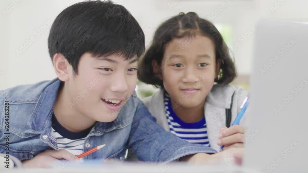 Young boys are using computers to teach and explain homework. To friends with facial expressions and happy gestures, Dolly shoot 60fps. Young boys are using computers to teach and explain homework. To friends with facial expressions and happy gestures, Dolly shoot 60fps.