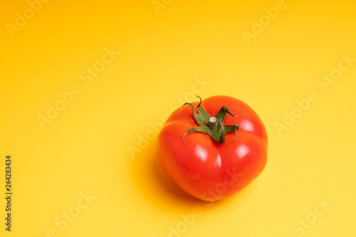 red tomato on a yellow background