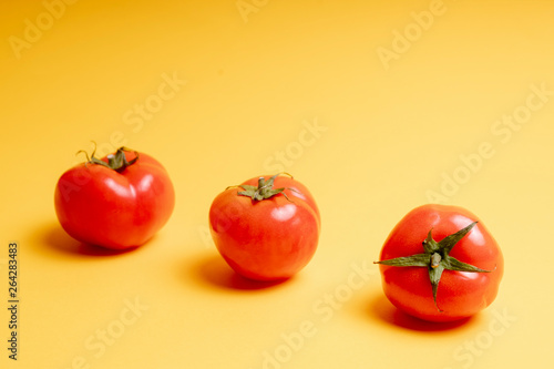 red tomatoes on a yellow background