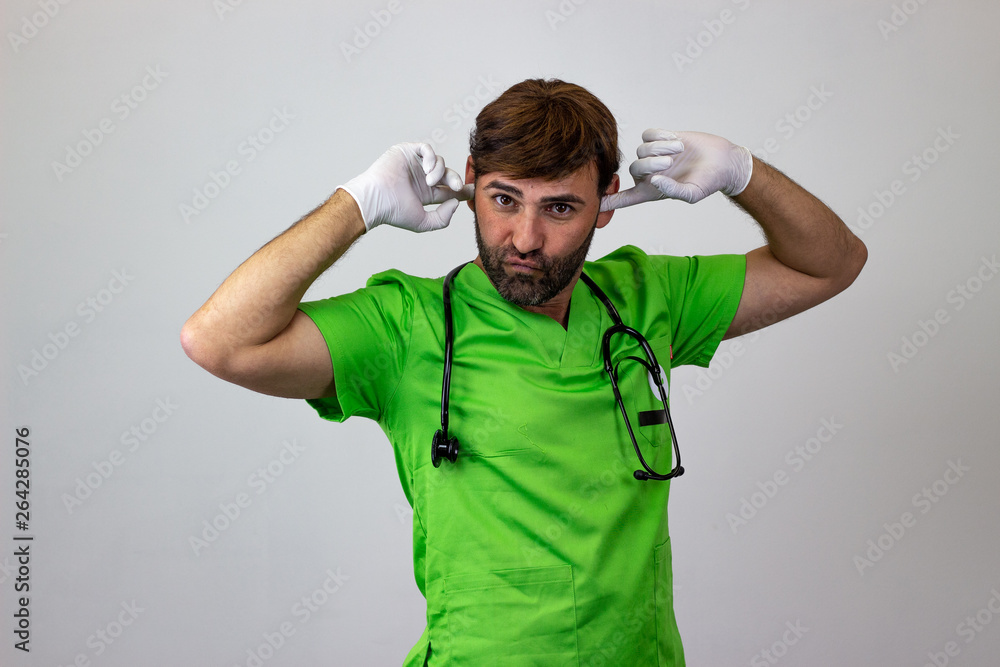 Portrait of male veterinary doctor in green uniform with brown hair covering the ears, their back facing the camera and looking at the camera. Isolated on white background. Portrait of male veterinary doctor in green uniform with brown hair covering the ears, their back facing the camera and looking at the camera. Isolated on white background.