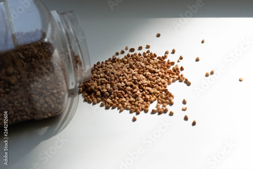 Buckwheat is spread over a white background