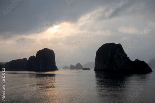 Sunset over karst rock foramtions in Ha Long Bay Vietnam
