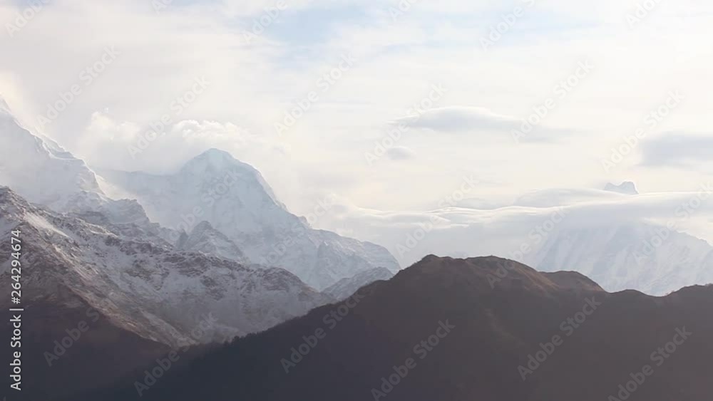 beautiful cloudy sunrise in the mountains with snow ridge and Annapurna summit in clouds. Trek around Annapurna mount. Himalaya, Nepal. Hiking and trekking in Nepal, spring trek to Annapurna mount. beautiful cloudy sunrise in the mountains with snow ridge and Annapurna summit in clouds. Trek around Annapurna mount. Himalaya, Nepal. Hiking and trekking in Nepal, spring trek to Annapurna mount.