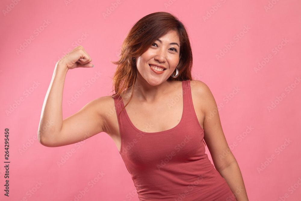 Beautiful young Asian woman flex bicep. Beautiful young Asian woman flex bicep.