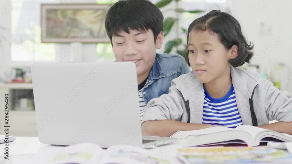 Young boys are using computers to teach and explain homework. To friends with facial expressions and happy gestures, Dolly shot 60fps. Young boys are using computers to teach and explain homework. To friends with facial expressions and happy gestures, Dolly shot 60fps.