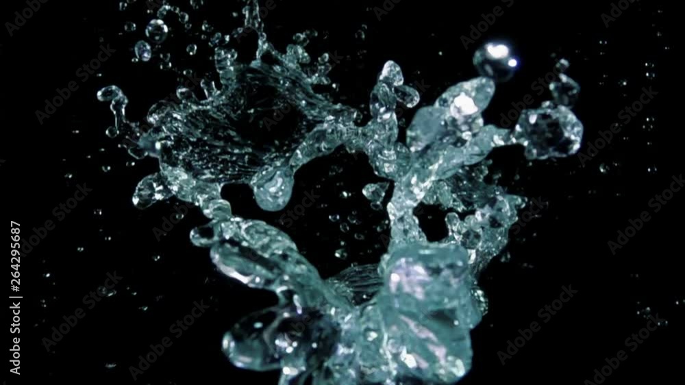 Water bouncing against to the camera on a black background in slow motion Water bouncing against to the camera on a black background in slow motion