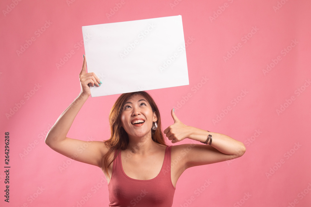 Young Asian woman show thumbs up with white blank sign. Young Asian woman show thumbs up with white blank sign.